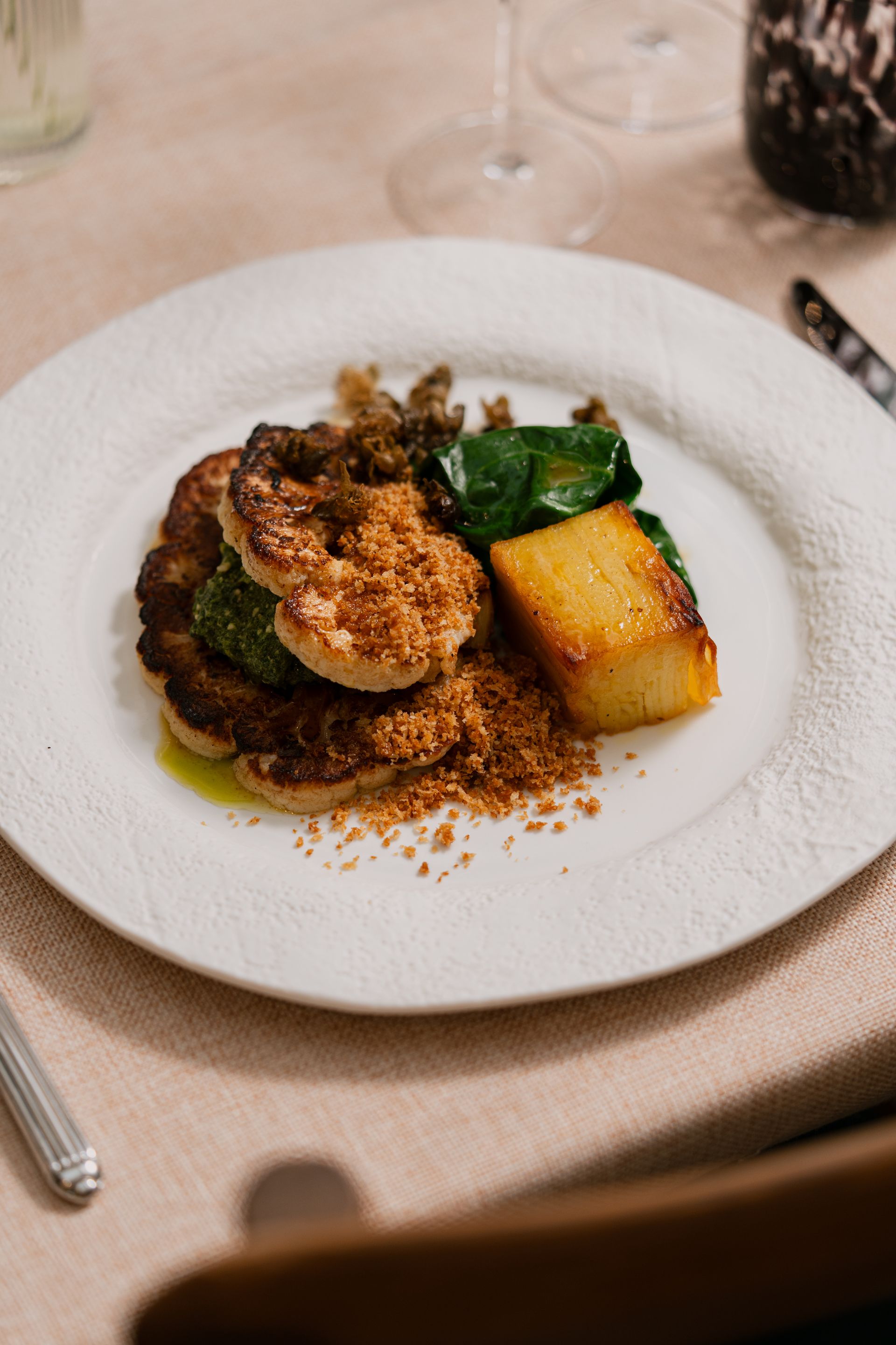 Cauliflower kiev, capers and parsley, pavé potatoes, wilted seasonal greens, garlic brown butter