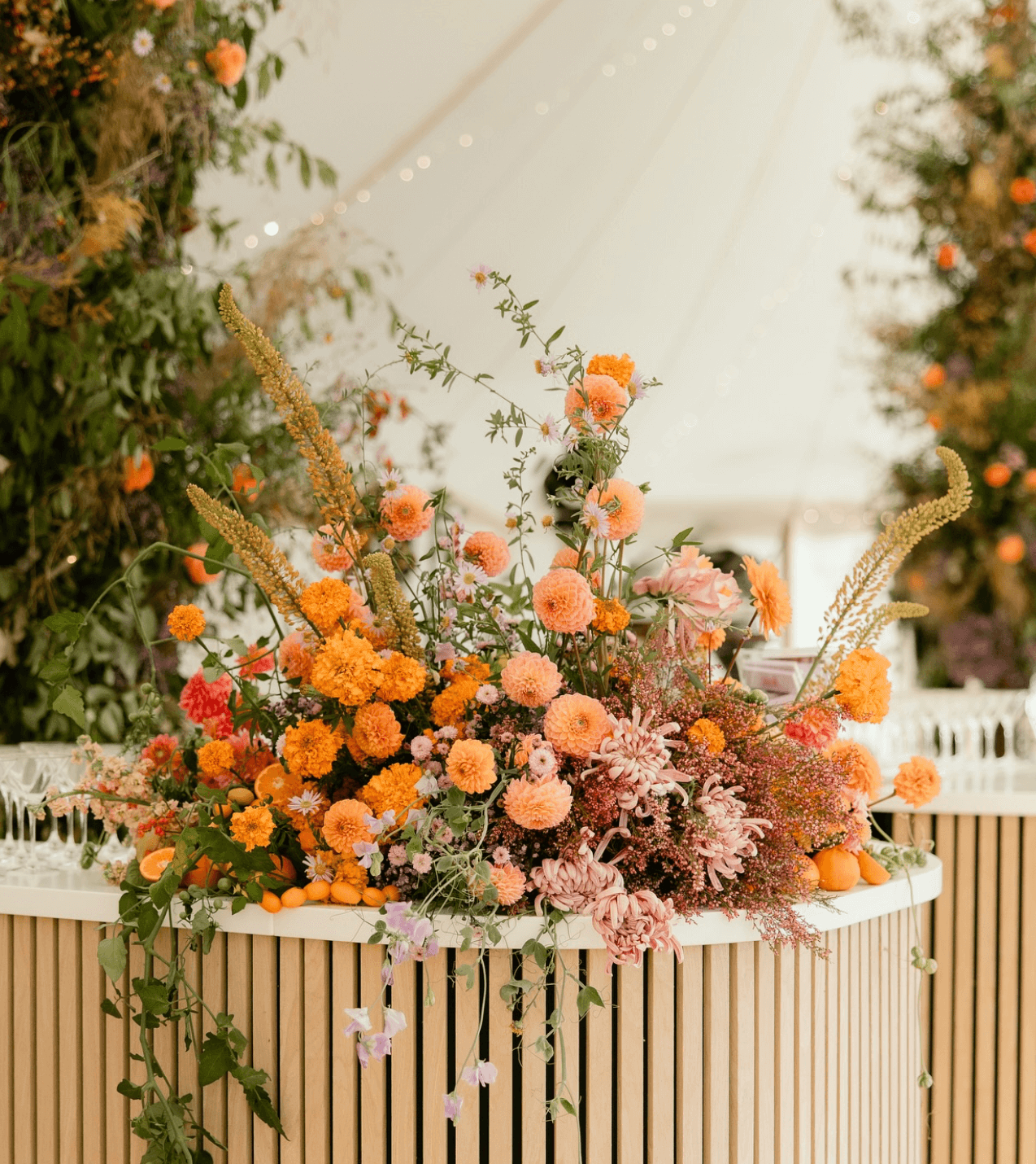 A bunch of flowers are sitting on top of a wooden table.