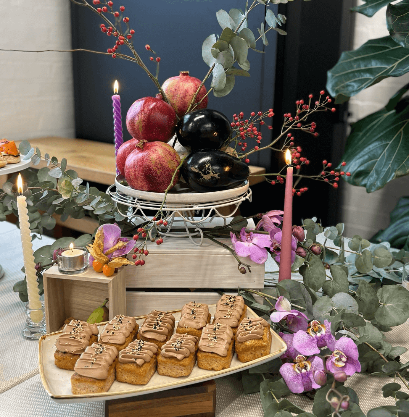 A table with a bunch of food and candles on it