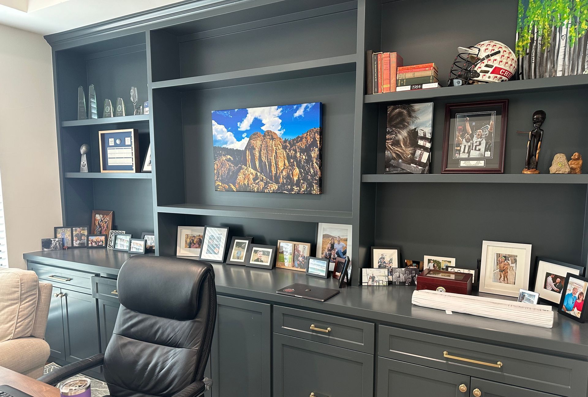 A wooden ladder is leaning against a wall next to buckets of paint.