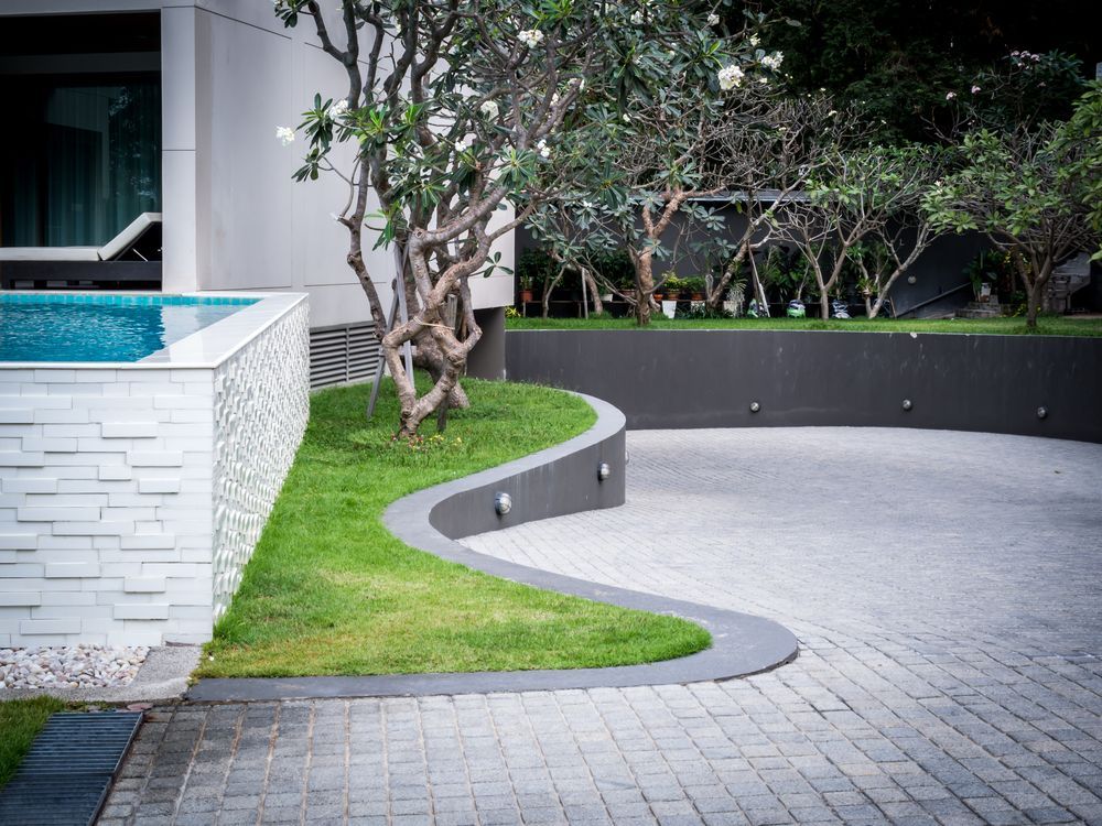 There is a Swimming Pool in the Backyard of a House — Brendan's Landscaping and Fencing In Bargara, QLD