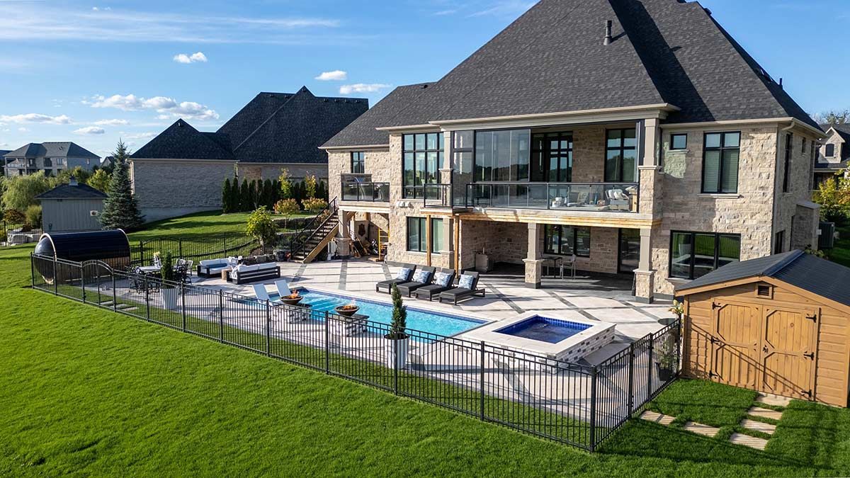 A Large House with A Large Swimming Pool in The Backyard — Brendan's Landscaping and Fencing In Bundaberg, QLD