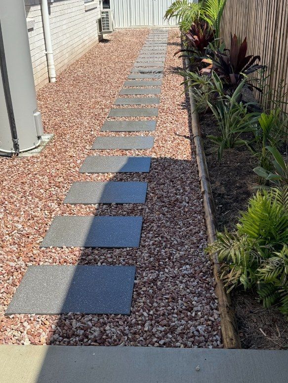 A Stone Walkway Leading to a House With Gravel and Plants — Brendan's Landscaping and Fencing In Bundaberg, QLD