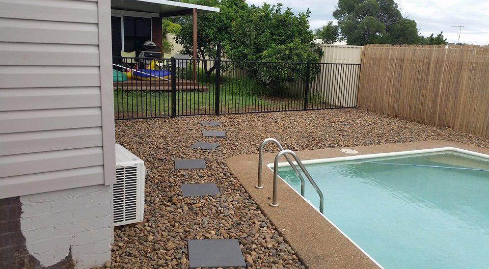 A Swimming Pool in the Backyard of a House — Brendan's Landscaping and Fencing In Bundaberg, QLD
