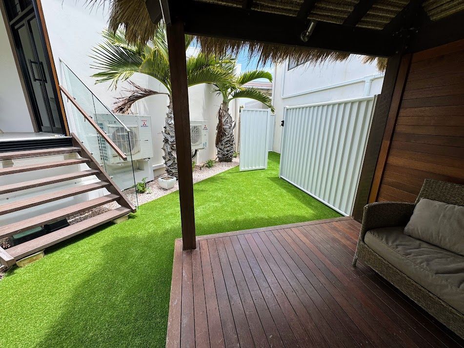 A Close Up of a Roll of Artificial Grass on a Lawn — Brendan's Landscaping and Fencing In Bundaberg, QLD