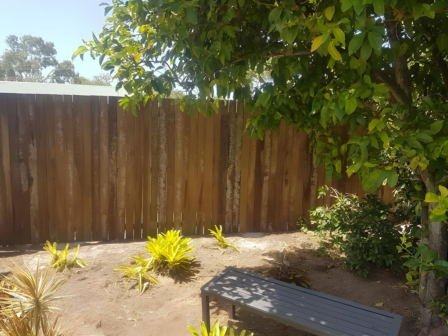 Timber Fence Bordering A Landscaped Garden