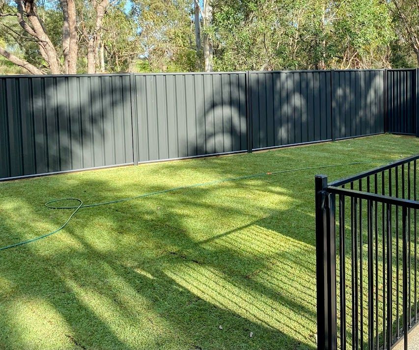Roll of Grass on Top of a Lush Green Lawn Next to a Pile of Dirt — Brendan's Landscaping and Fencing In Bundaberg, QLD