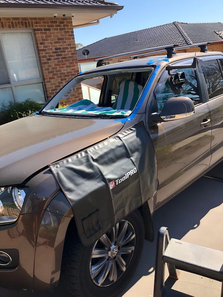 A Car With A Fender Protector On It Is Parked In Front Of A House — Canberra Windscreens In Conder, ACT