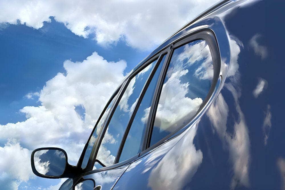 A Close Up Of A Car Window With Clouds Reflected In It — Canberra Windscreens In Conder, ACT