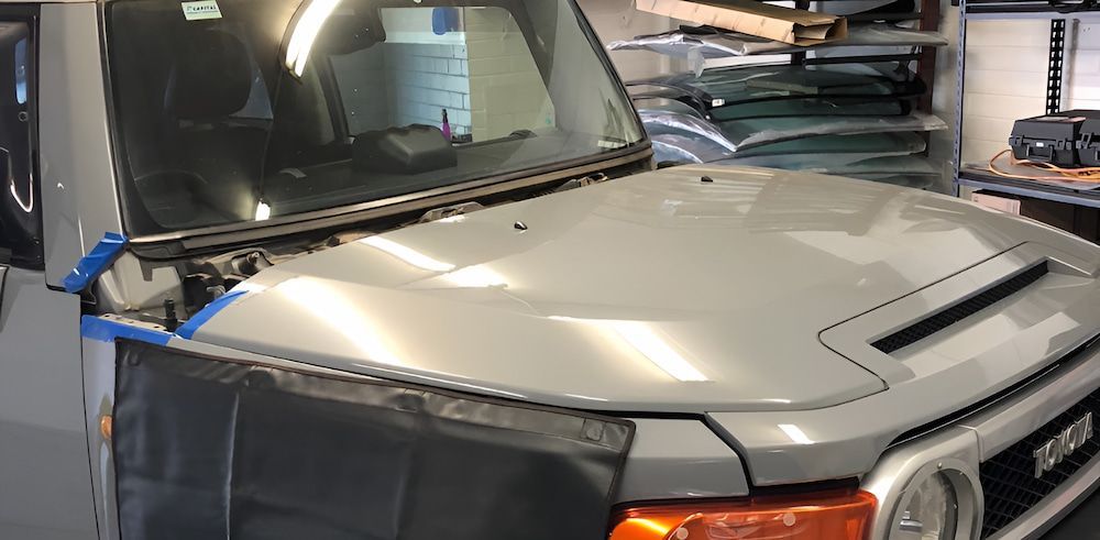 A Toyota Fj Cruiser Is Being Repaired In A Garage — Canberra Windscreens In Conder, ACT