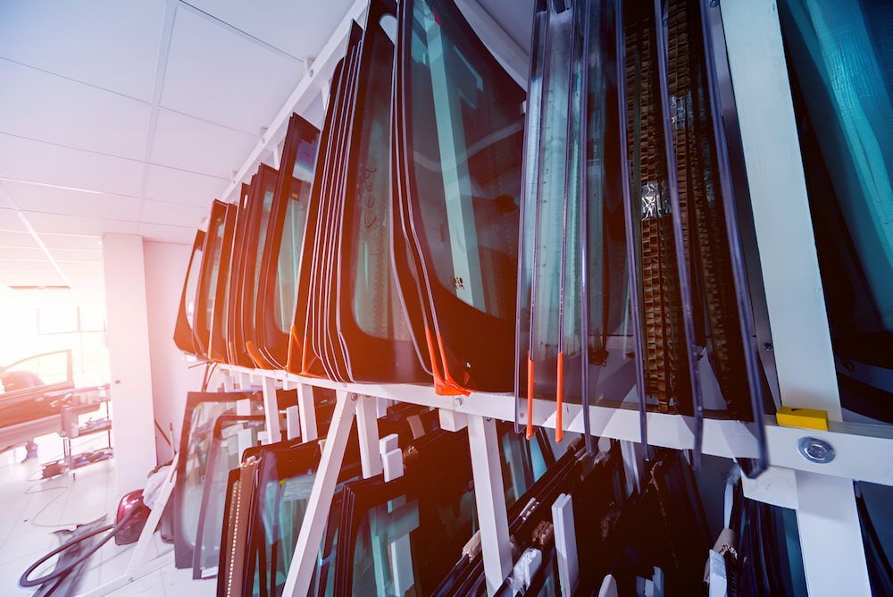 A Row Of Car Windshields Hanging On A Rack In A Store — Canberra Windscreens In Gungahlin, ACT
