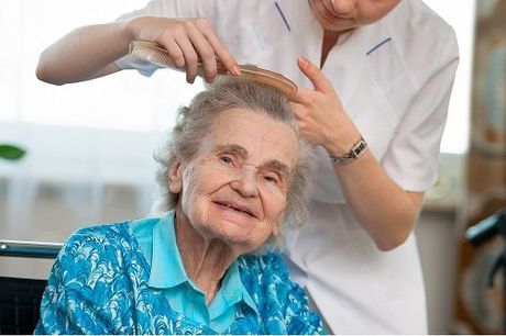 Caregiver brushes hair personal care