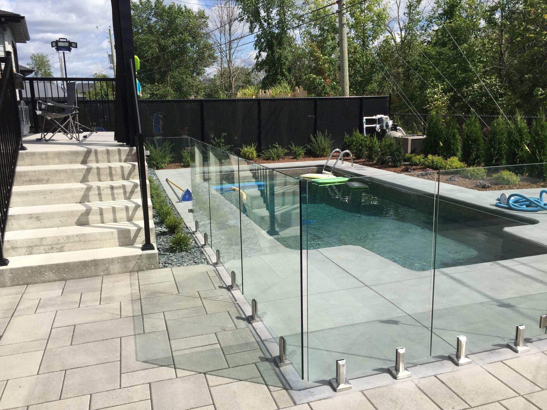 custom glass railing around a pool
