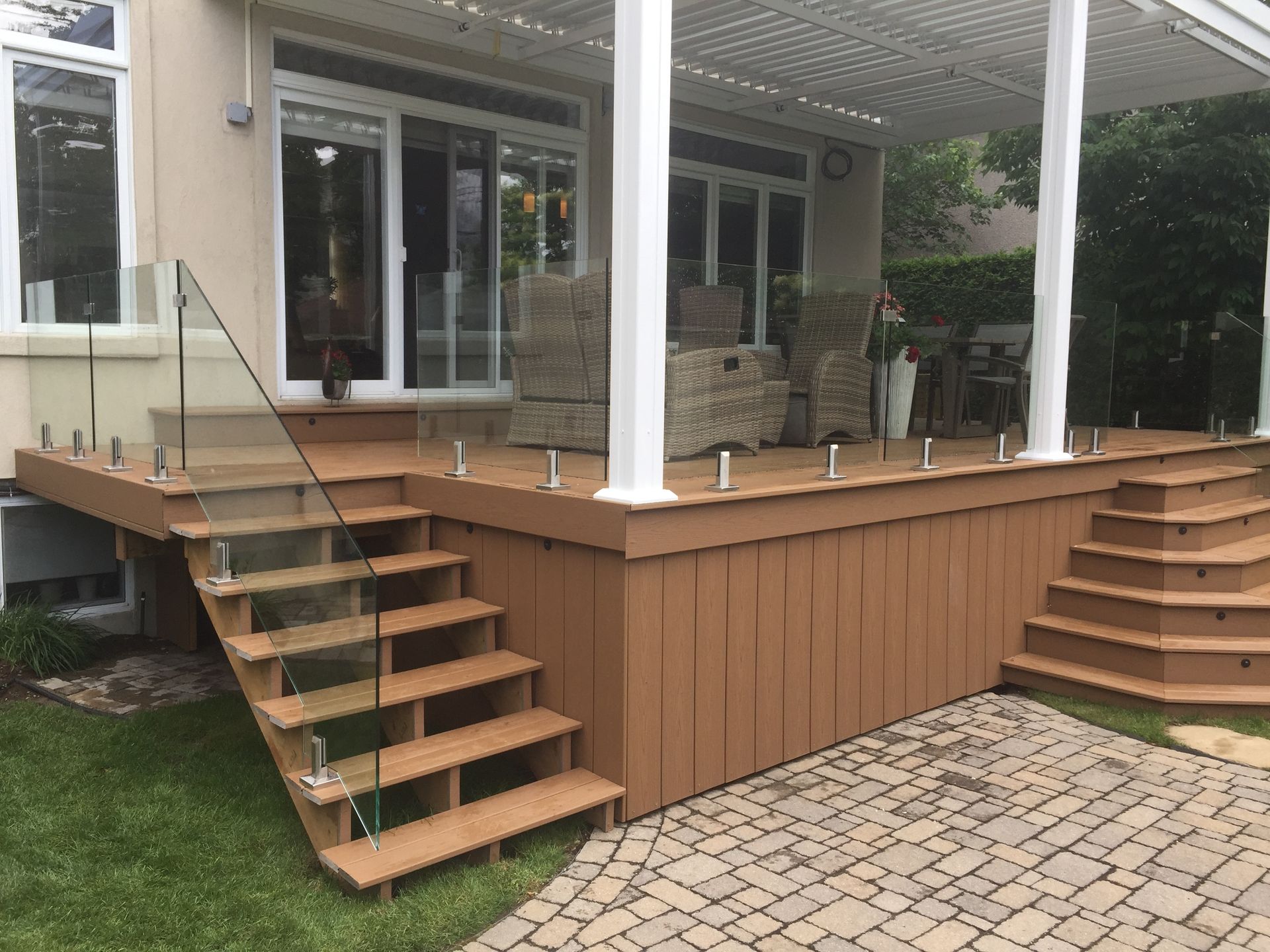 custom glass railing on stairs and deck
