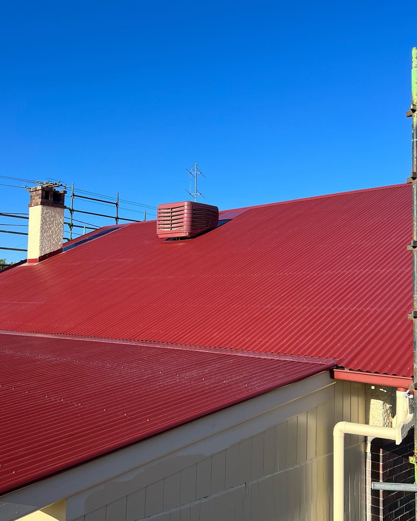 Red Corrugated Metal Roof of a Building With a Vent — Ace Metal Roofing in Maclean, NSW