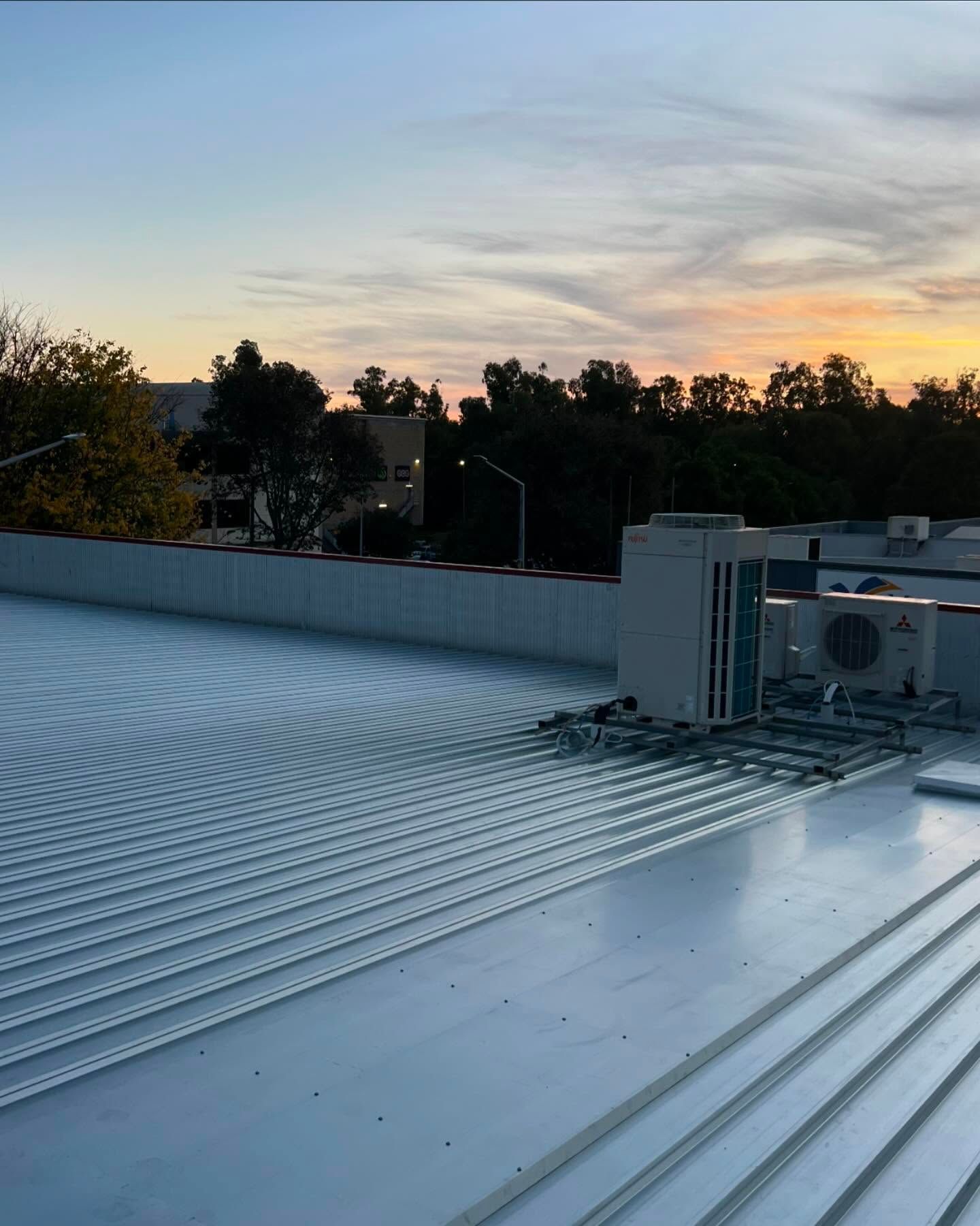 View of a white commercial rooftop with HVAC units — Ace Metal Roofing in Iluka, NSW