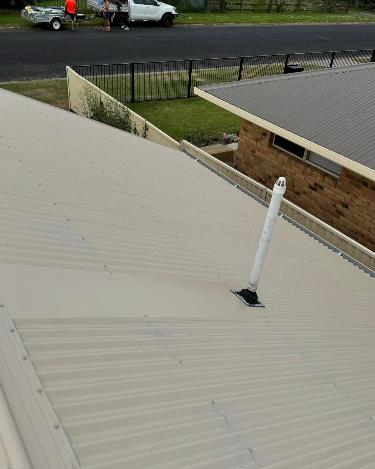 Beige Corrugated Metal Roof With White Pipe — Ace Metal Roofing in Ballina, NSW