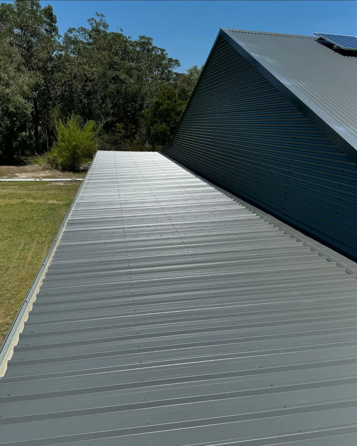 Gray Corrugated Metal Roof on a Building, With a Slanted, Metal Section — Ace Metal Roofing in Waterview Heights, NSW