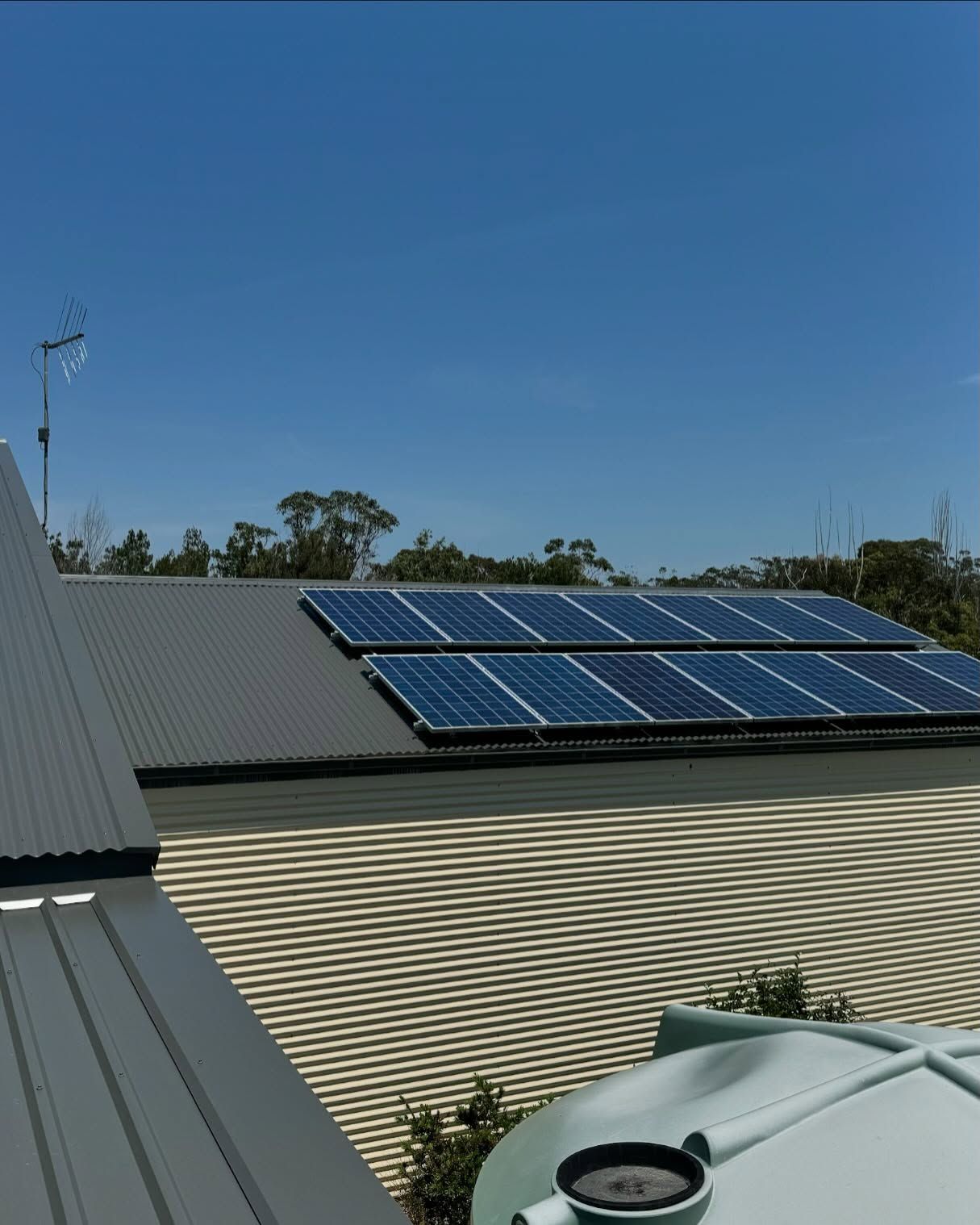 Solar Panels Installed on a Corrugated Metal Roof Under a Blue Sky — Ace Metal Roofing in Waterview Heights, NSW