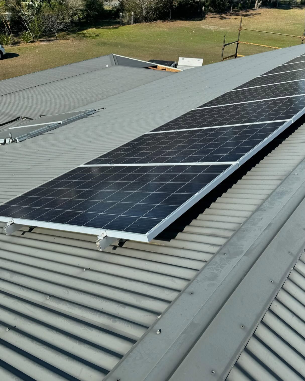 Solar Panels on a Metal Roof, Reflecting Sunlight — Ace Metal Roofing in Waterview Heights, NSW