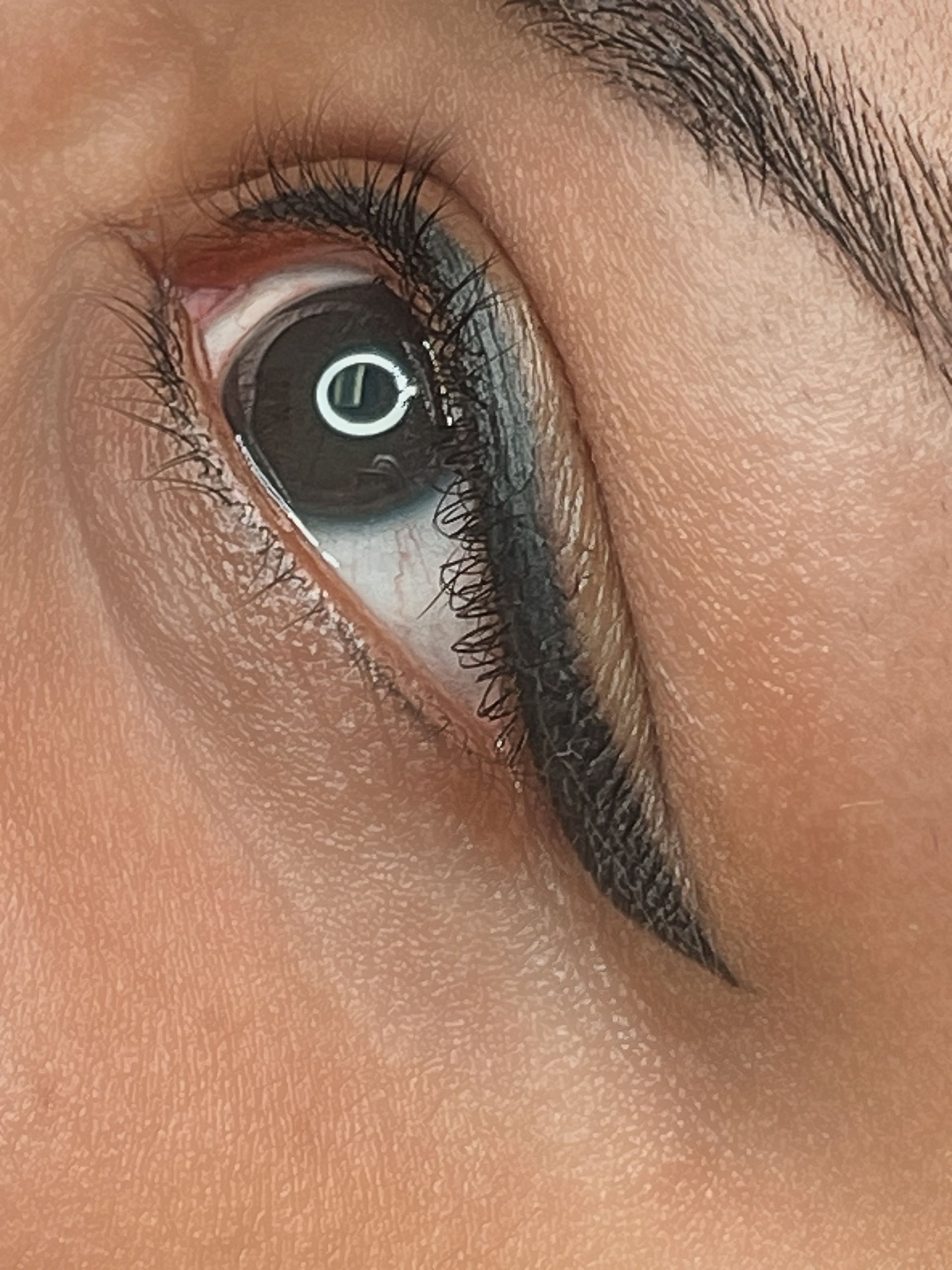 Close-up of an eye with black eyeliner. The wing extends outwards.