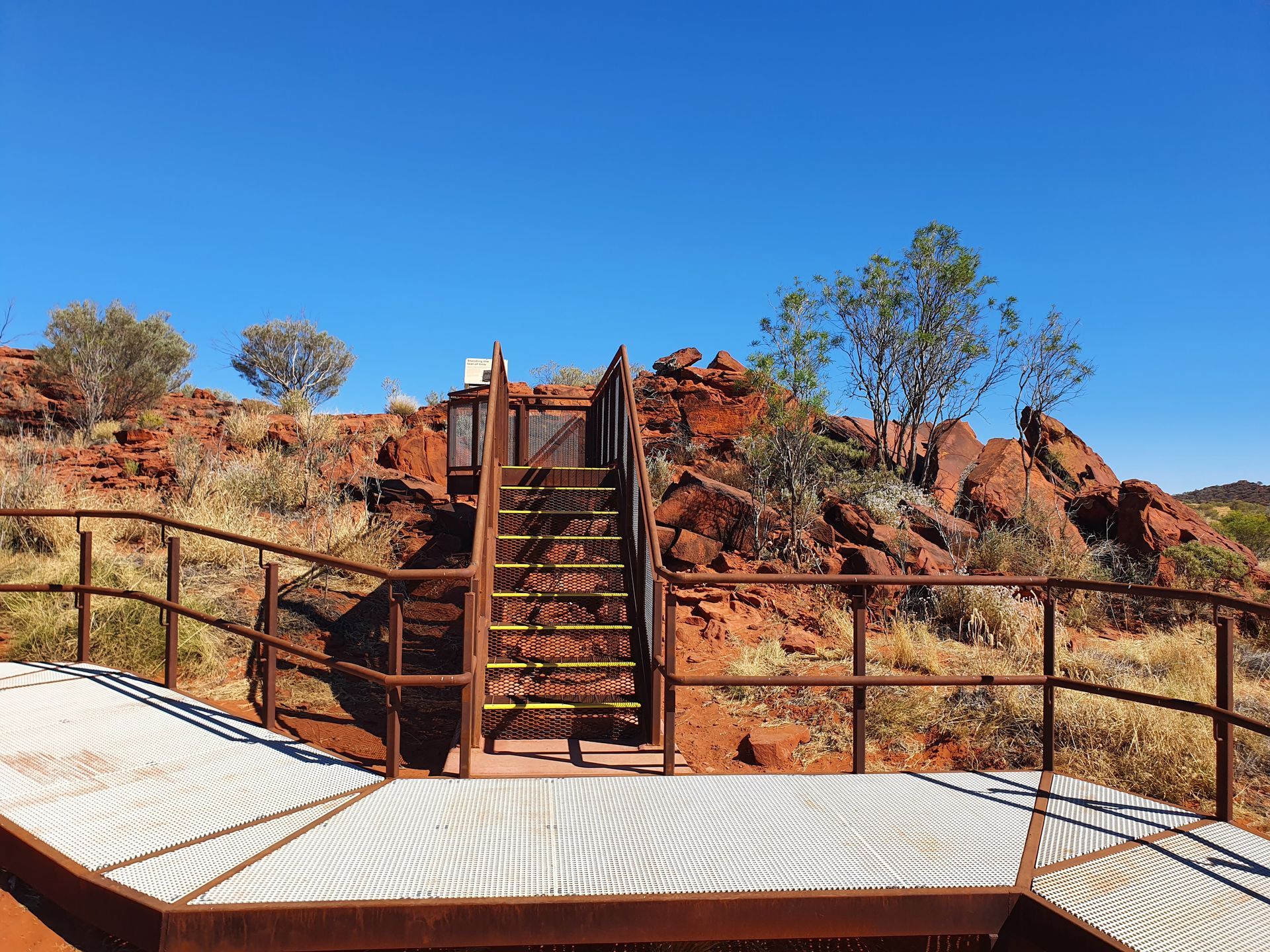 A set of stairs leading up to a platform in the desert