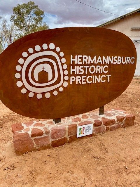 A sign that says hermannsburg historic precinct on it