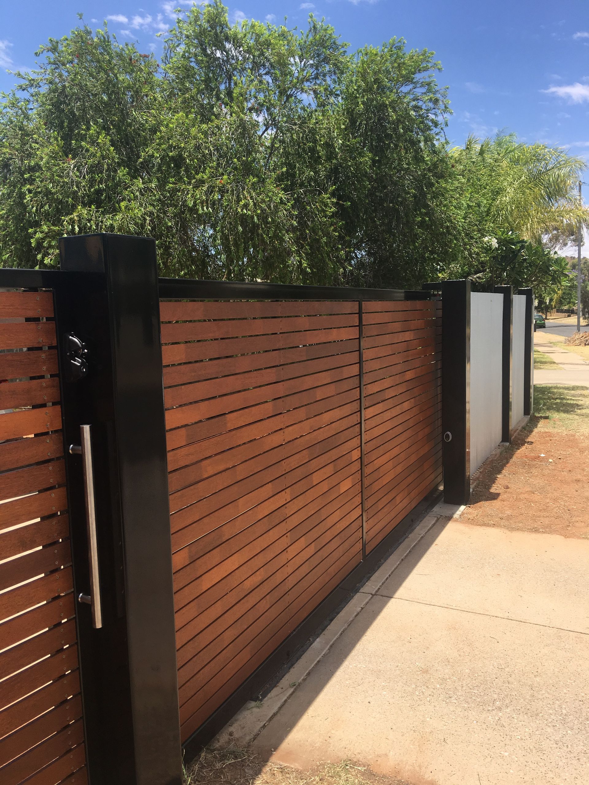 A wooden fence with trees in the background