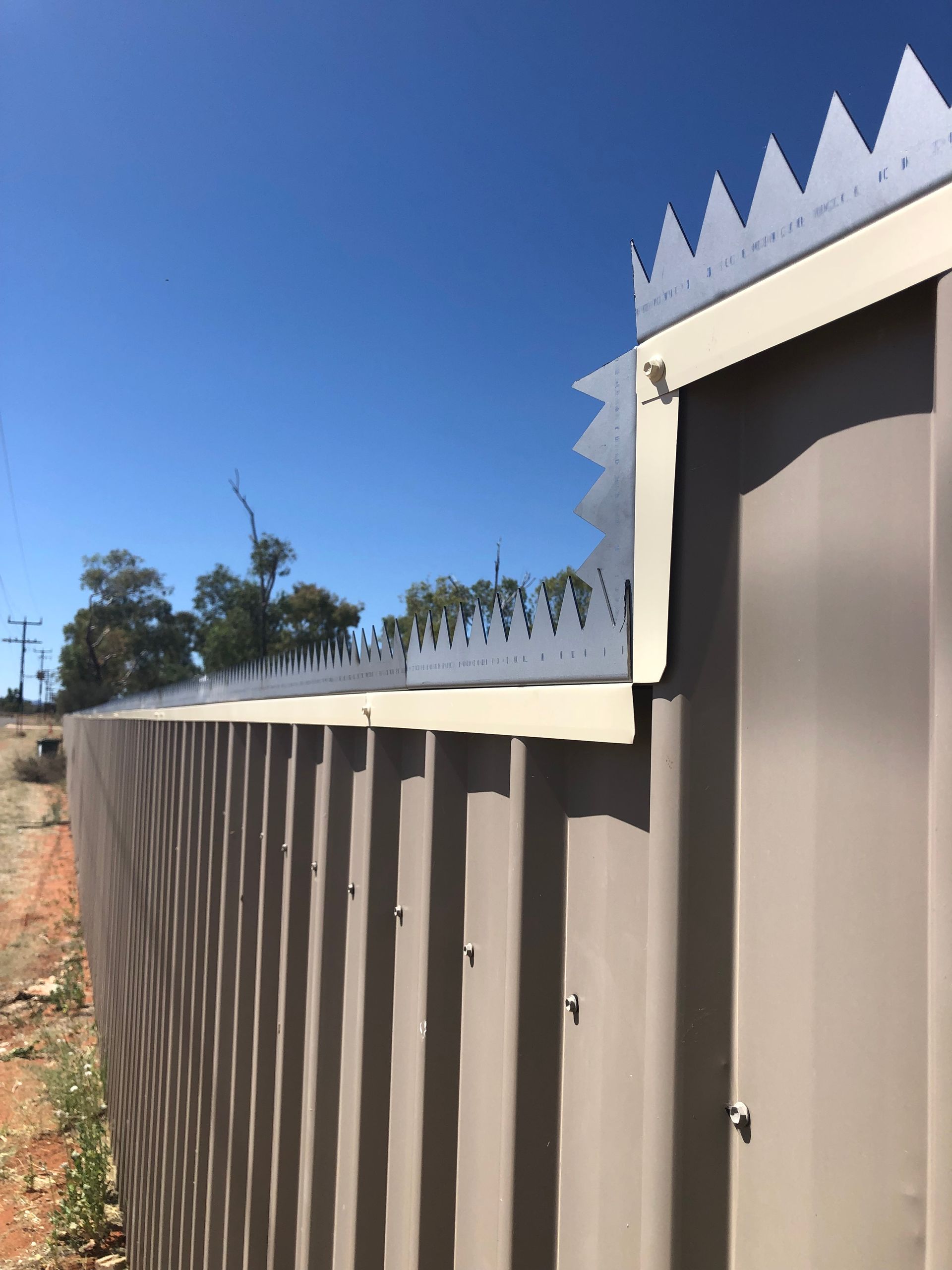 A close up of a fence with spikes on it