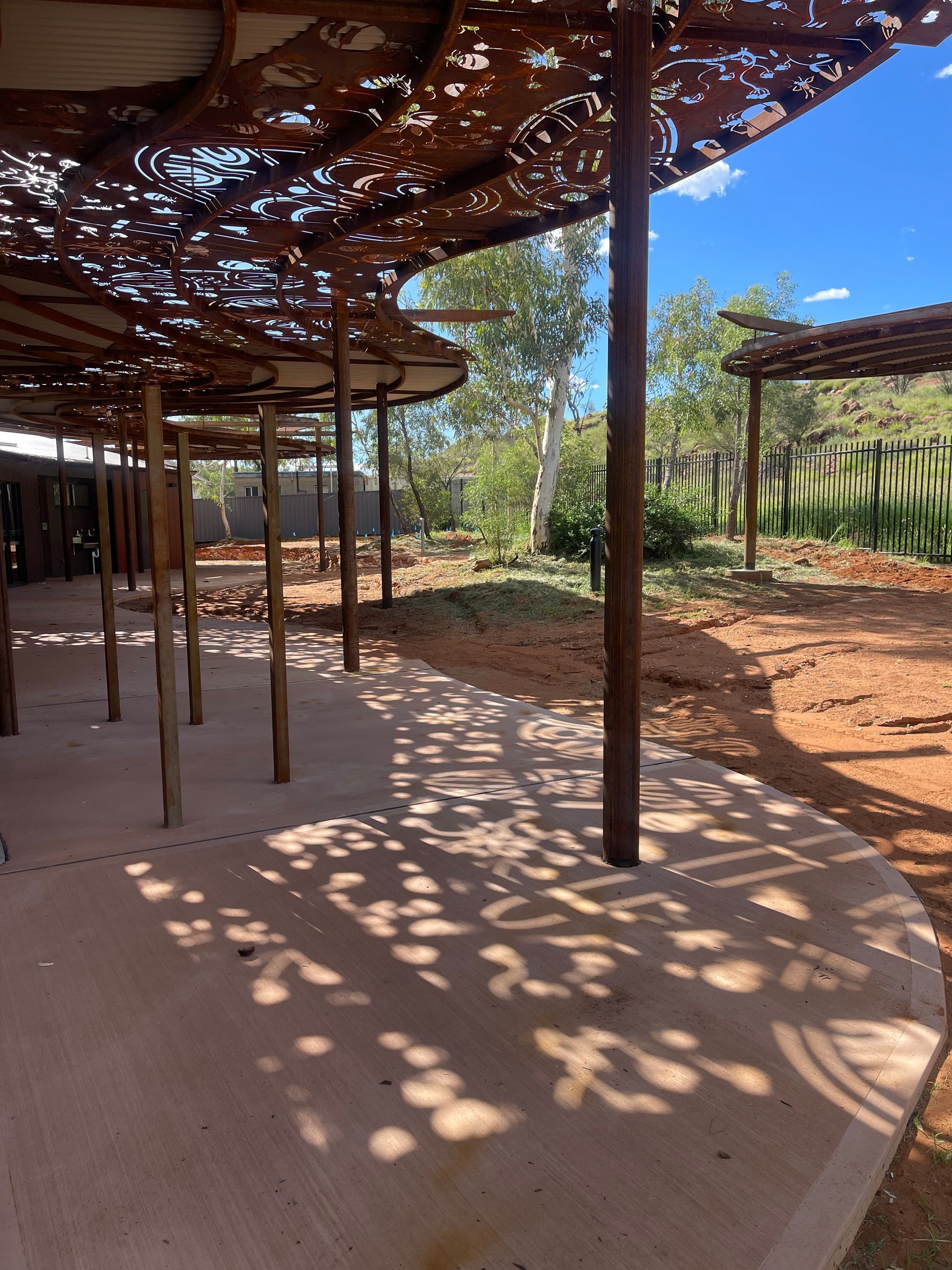 A wooden structure with a shadow on the ground