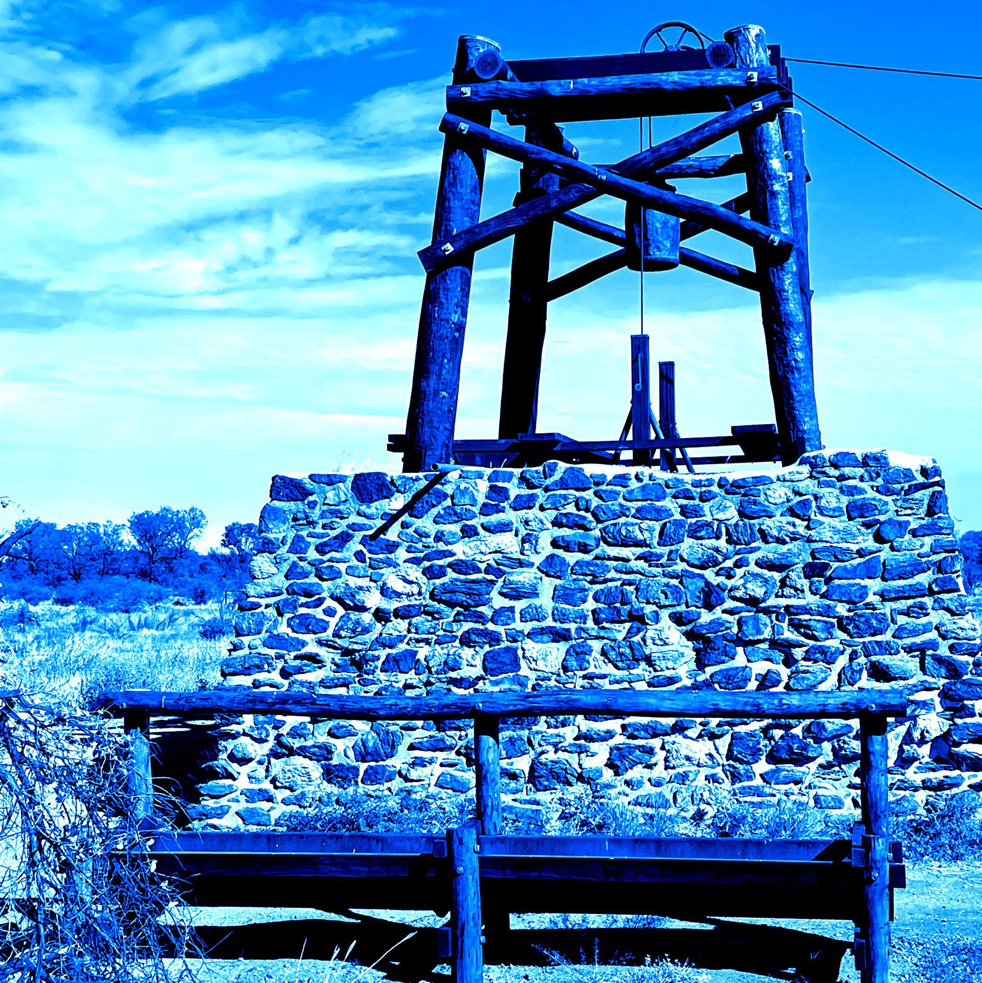 A wooden tower is sitting on top of a pile of rocks