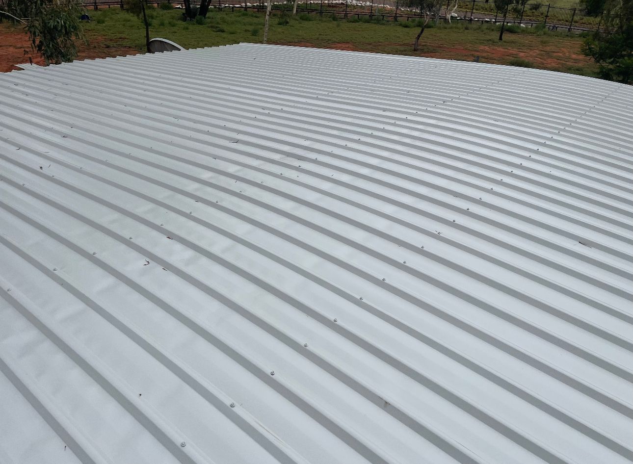 A white metal roof with a lot of lines on it