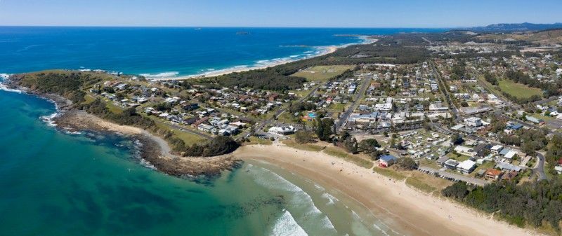 Aerial View of a Coastal Town With a Sandy Beach, Blue Ocean — Mid North Coast Solar Carports in Woolgoolga, NSW