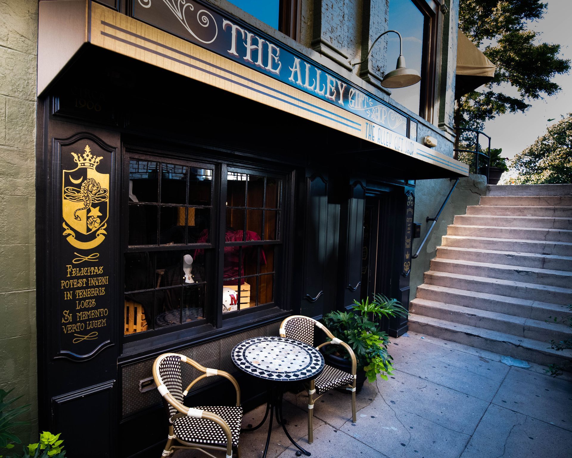 A restaurant called the alley has a table and chairs outside