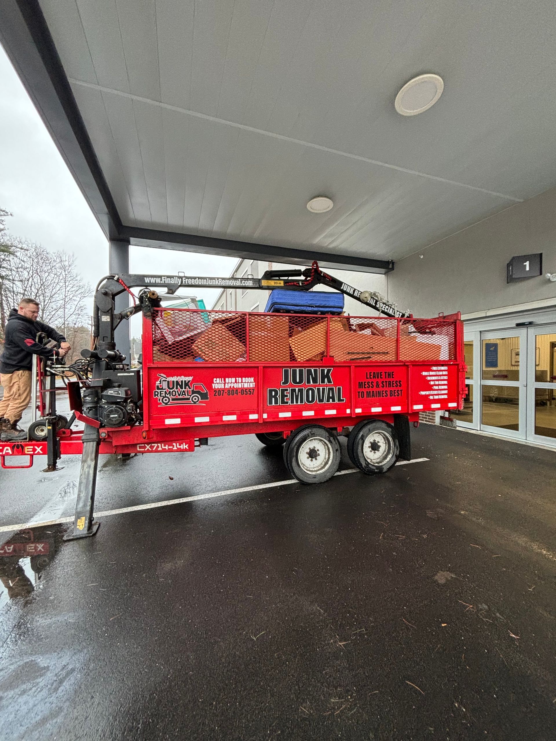 Finally Freedom Junk Removal with a trailer filled with boxes