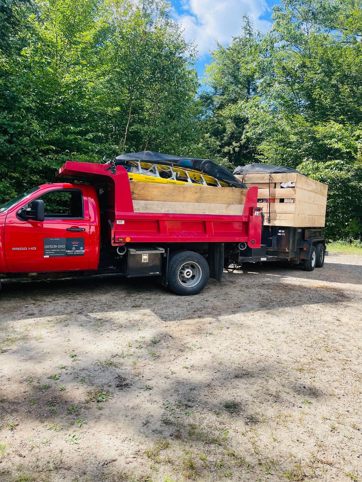 Finally Freedom Junk Removal truck and trailers