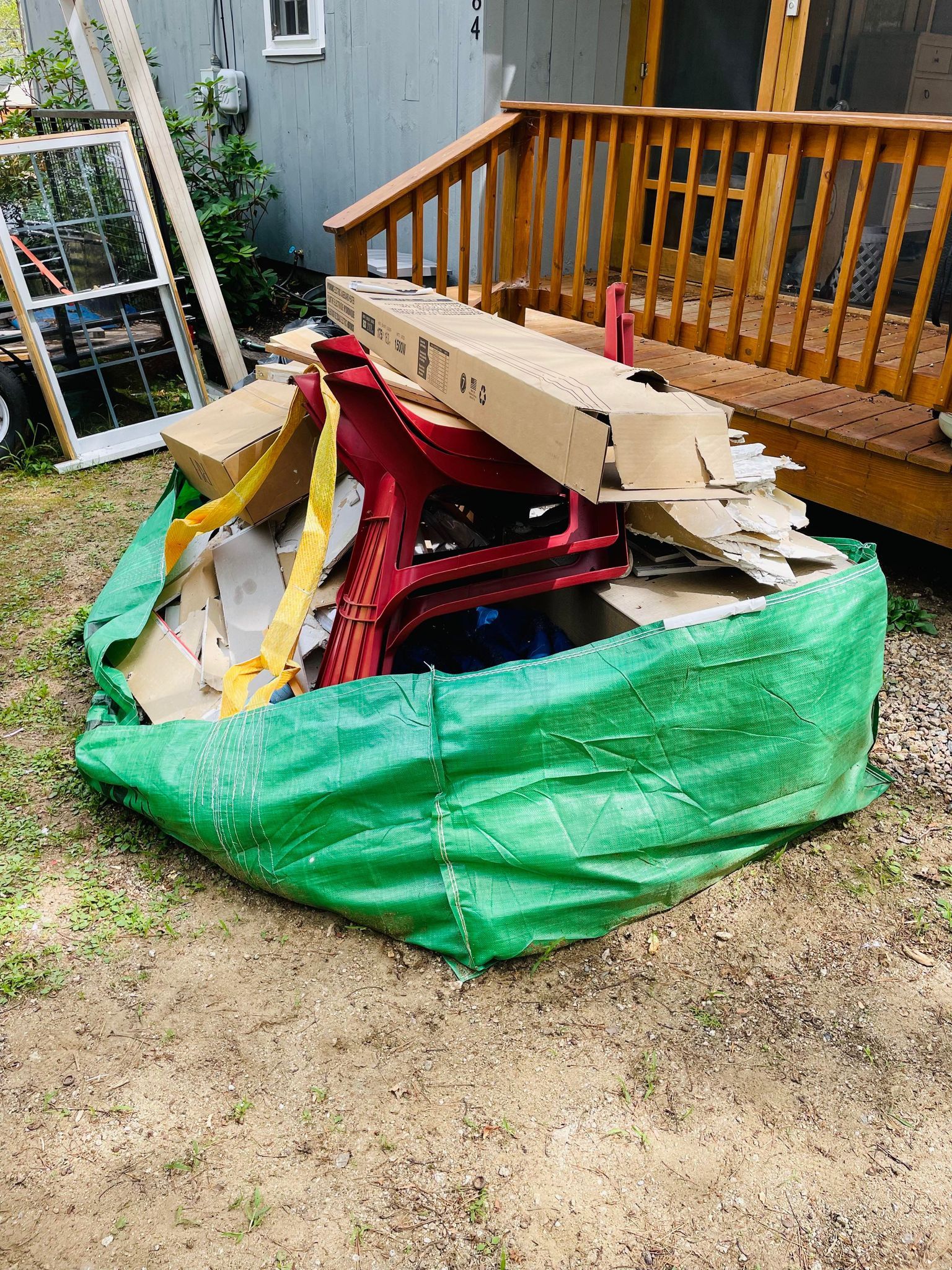 broken saw horse and debris in construction waste bag