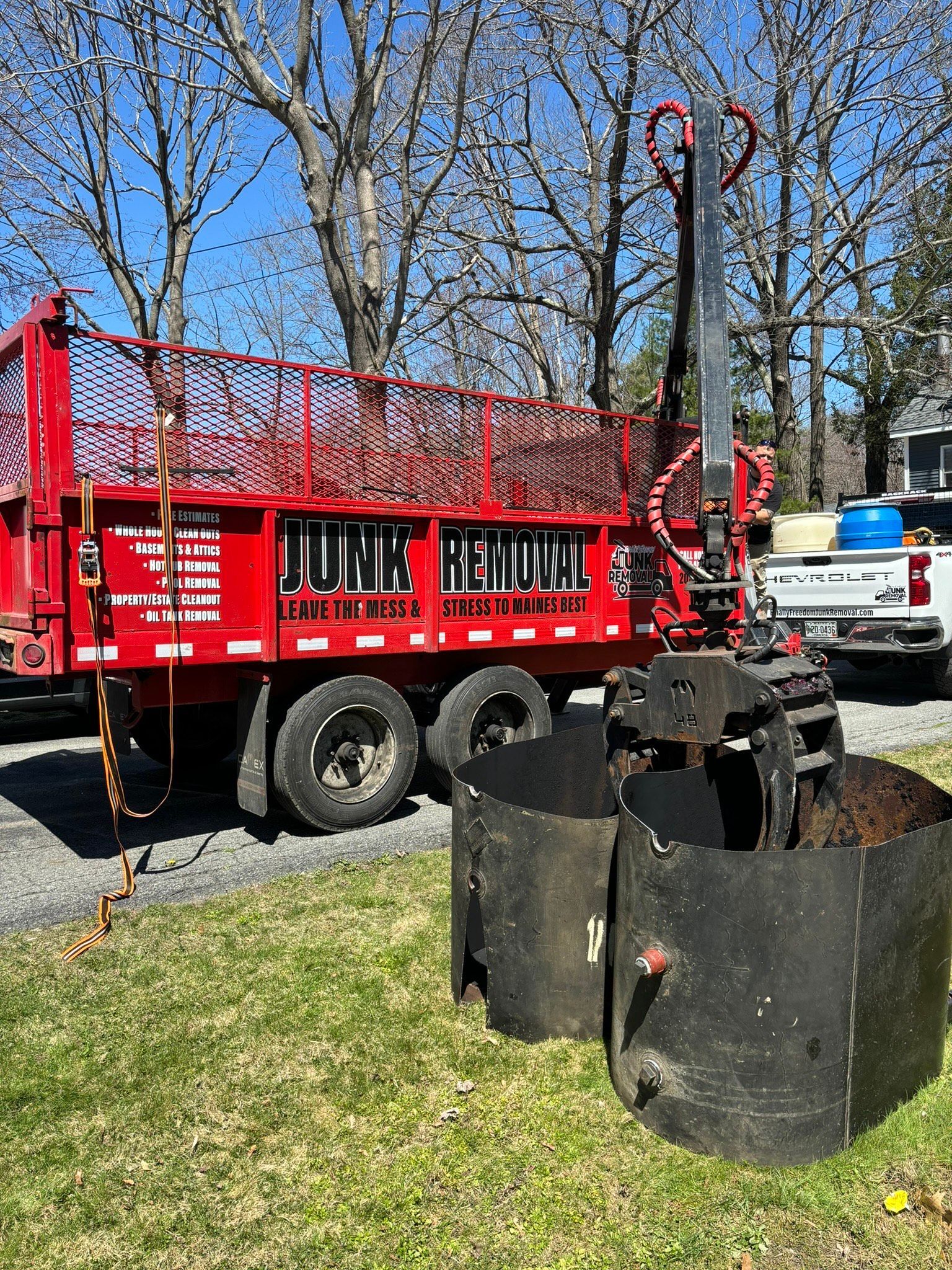 Finally Freedom Junk Removal removing a residential oil tank with their truck's crane