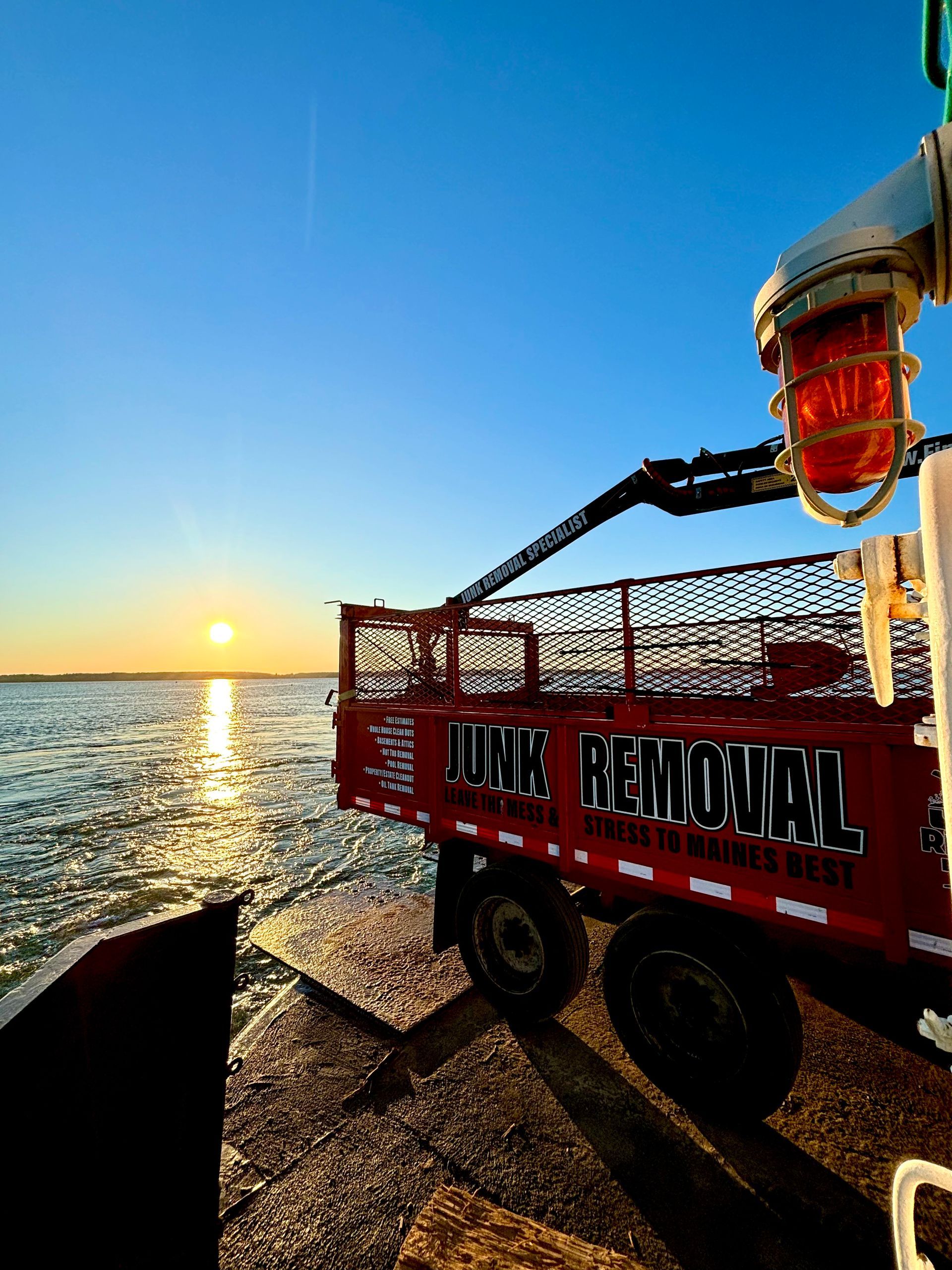 Finally Freedom Junk Removal's Truck parked by the Maine coast overlooking the sea