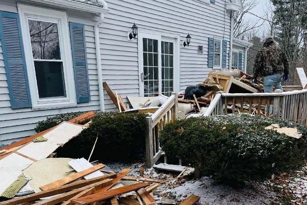 Image of a home with junk piled up on the front deck