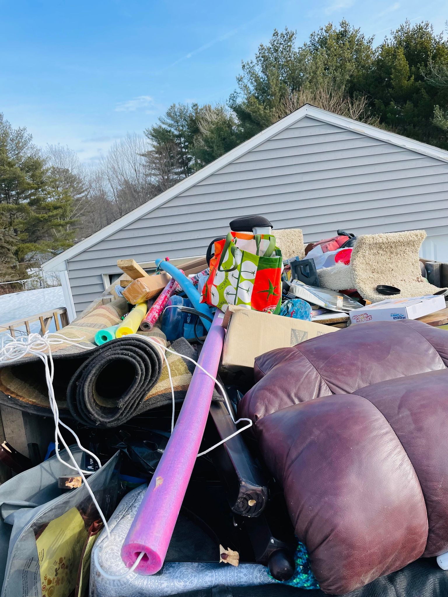 top view of trailer full of pool toys, furniture, and other junk