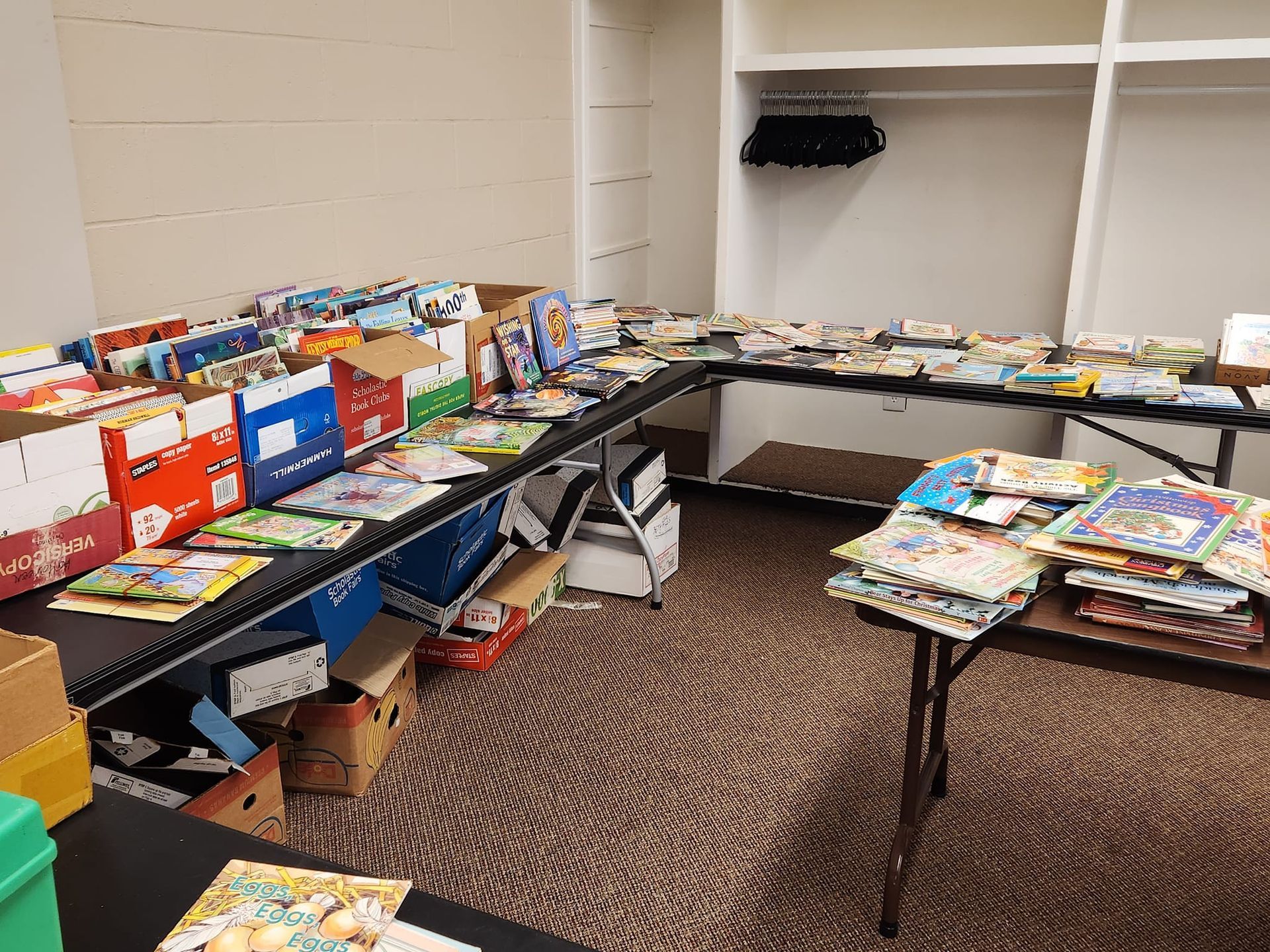 Books displayed on tables and in boxes; likely a book sale.