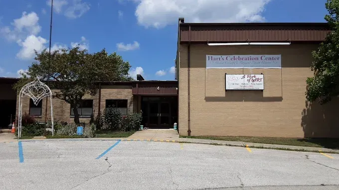 Tan brick building with a sign: 