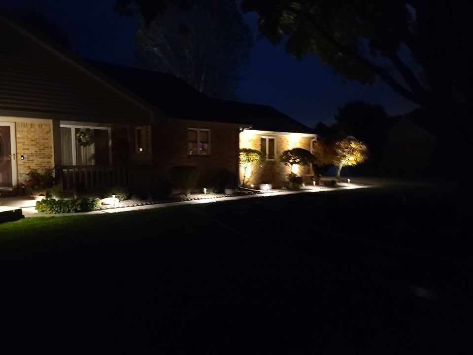 A house is lit up at night with a lot of lights