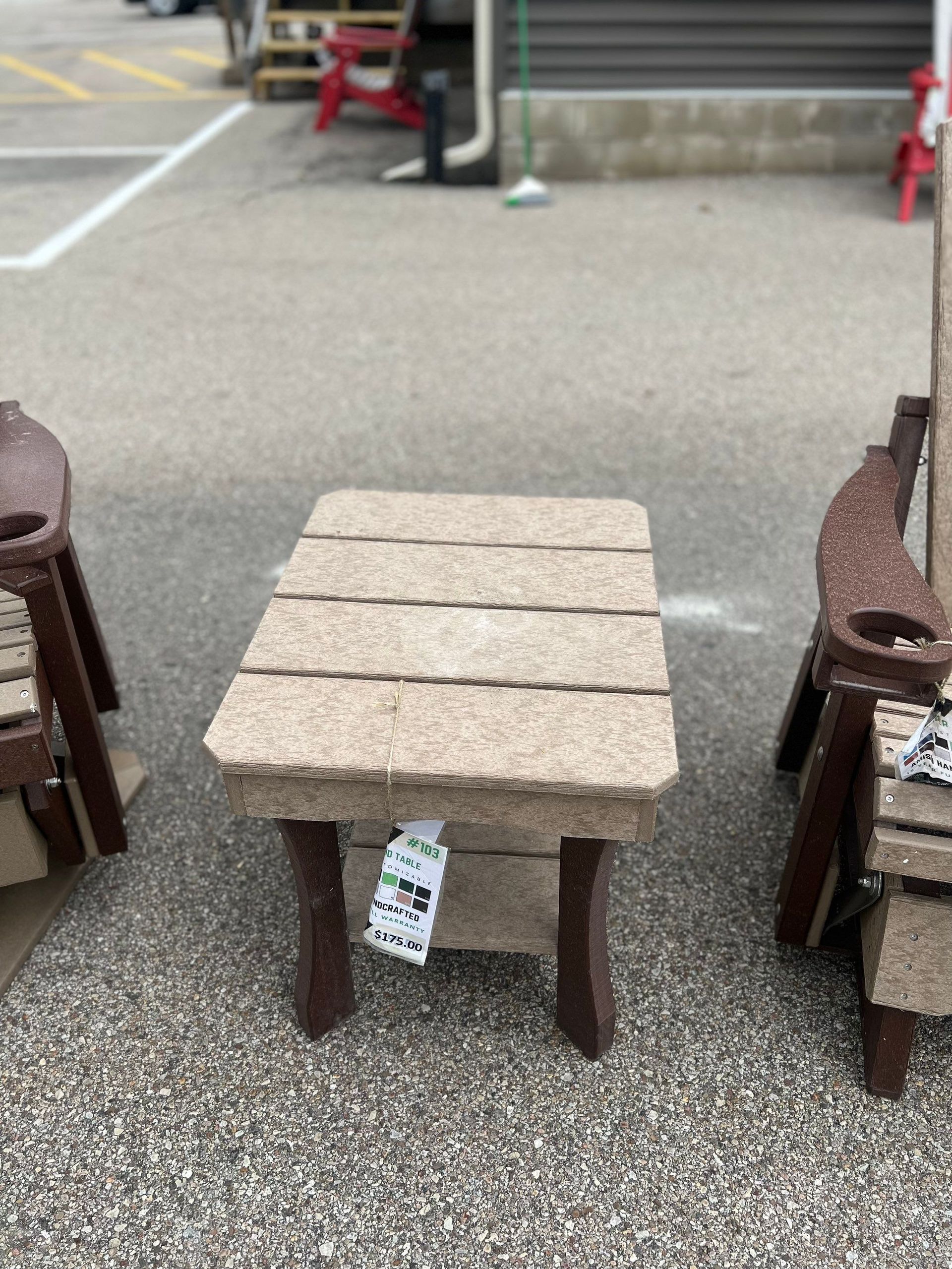 A table and chairs are sitting on the ground in a parking lot.