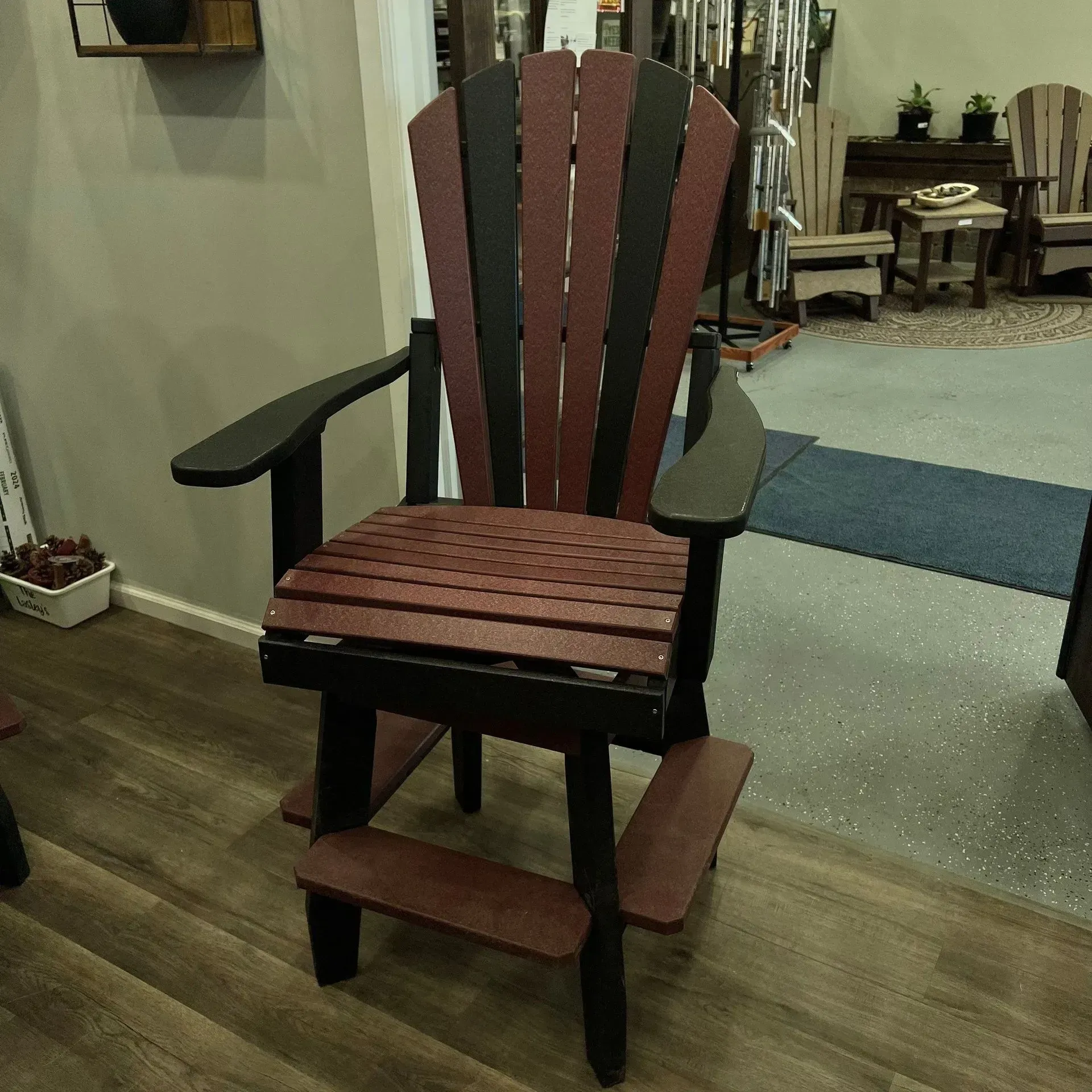 A red and black chair is sitting on a wooden floor