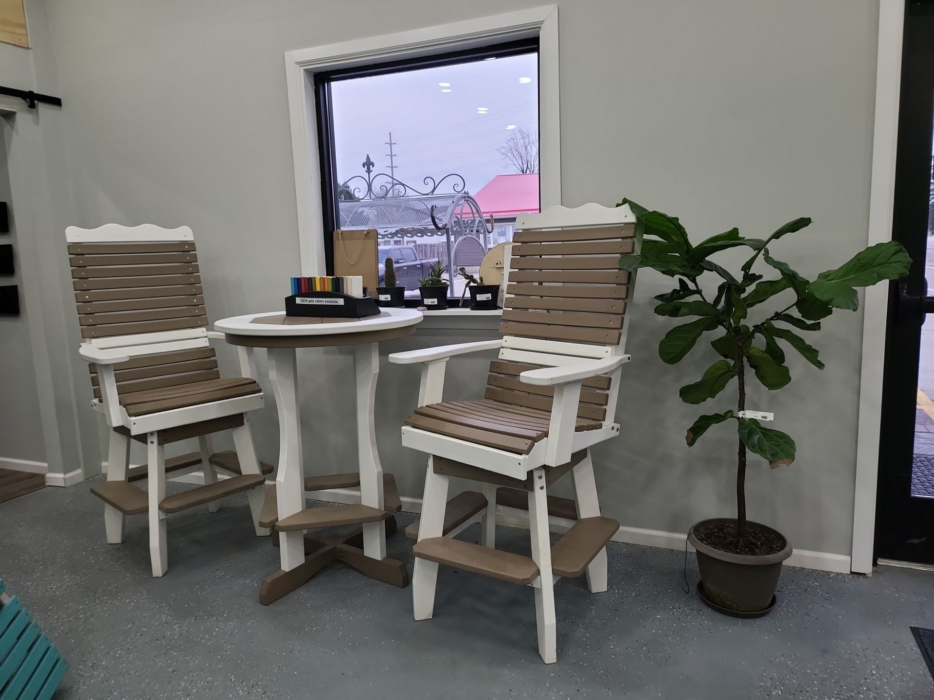 Two chairs and a table are sitting in front of a window in a room.