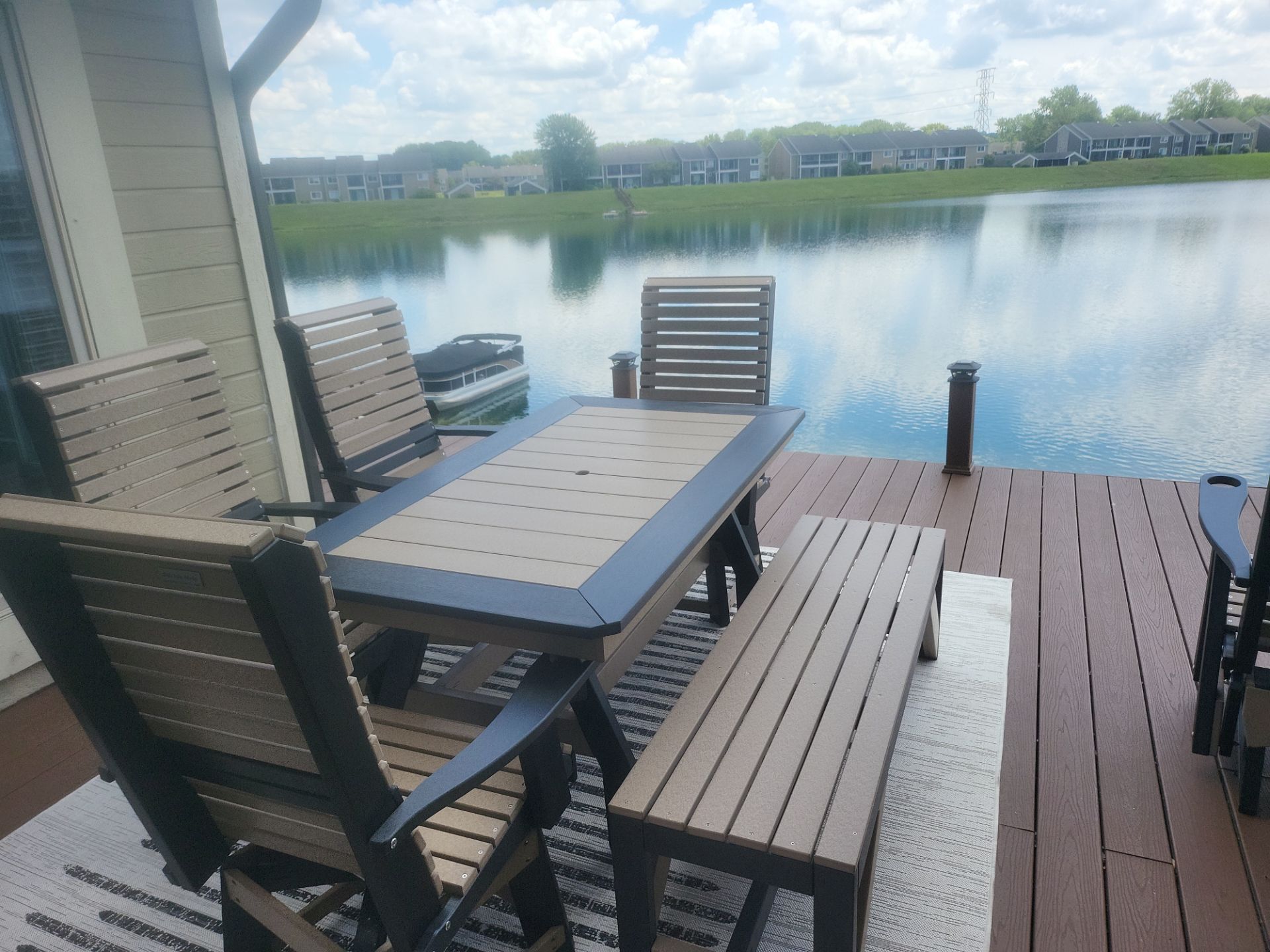 A table and chairs on a deck overlooking a lake