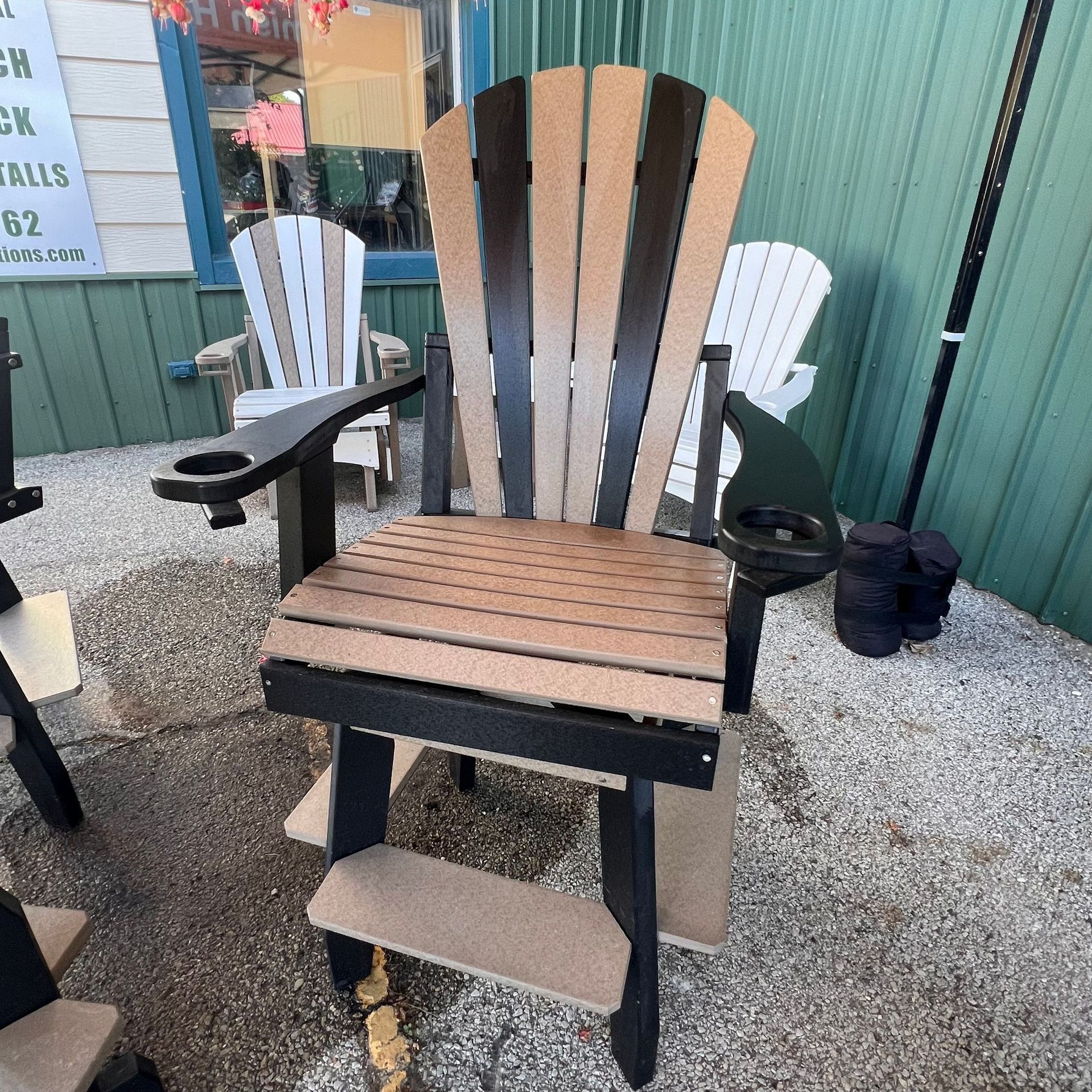 A wooden chair with a drink holder on the arm