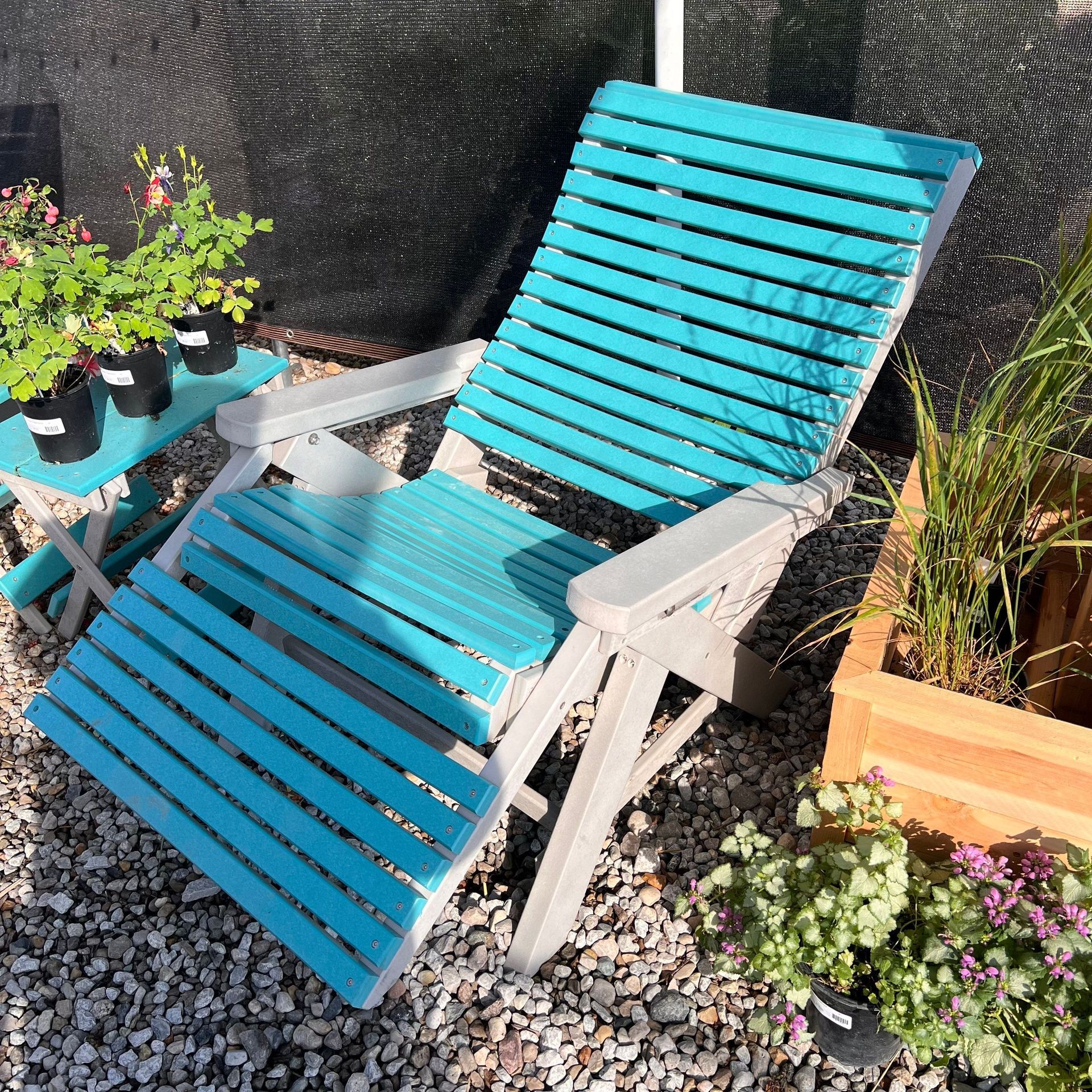 A blue and white chair is sitting in the gravel